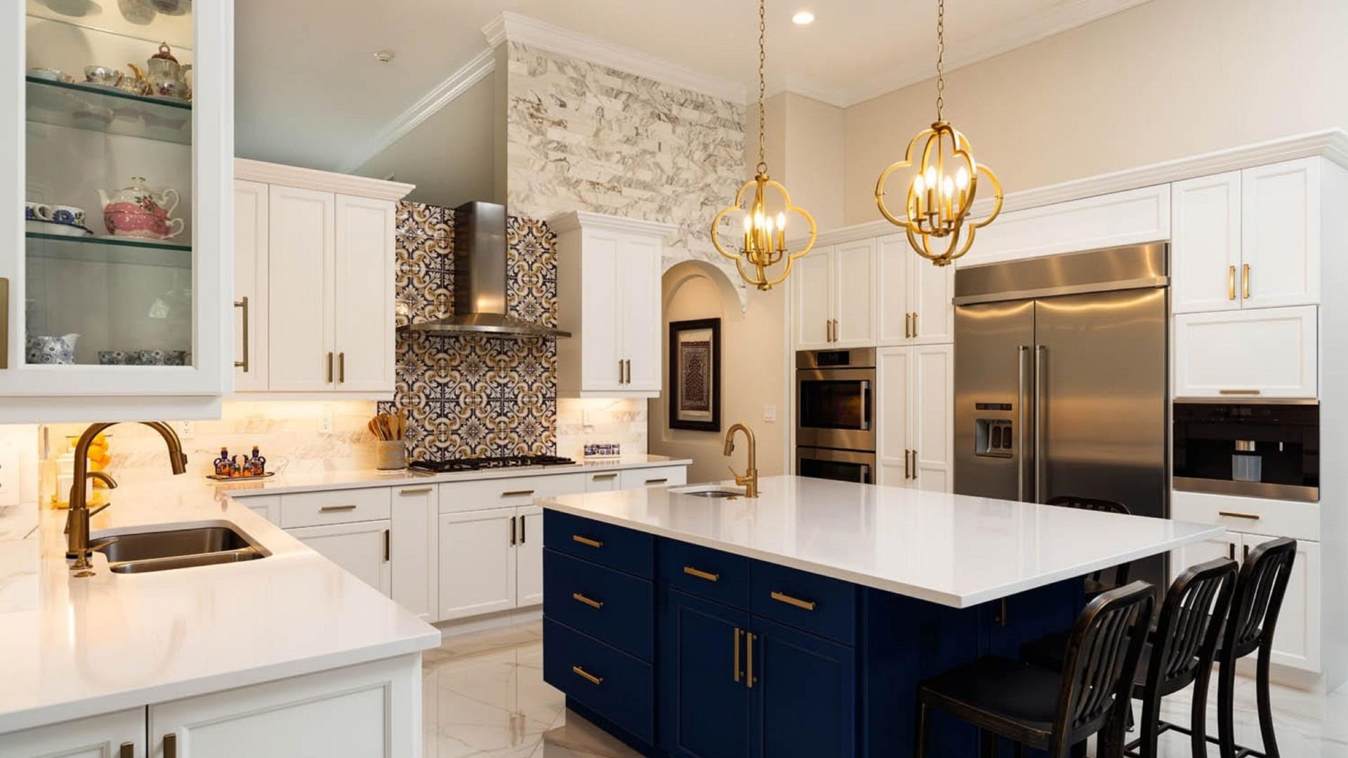 Elegant kitchen with white cabinets, blue island, golden light fixtures